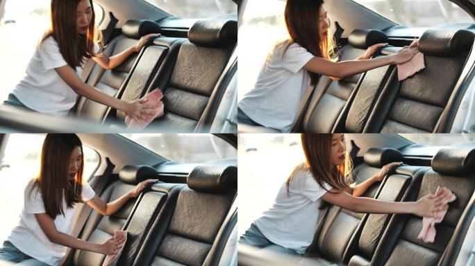 亚洲少女用吸尘器清洁汽车