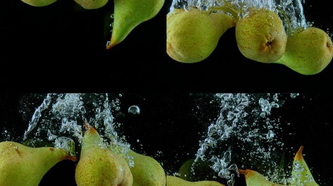 缓慢的梨子掉进水中并产生漩涡状的气泡