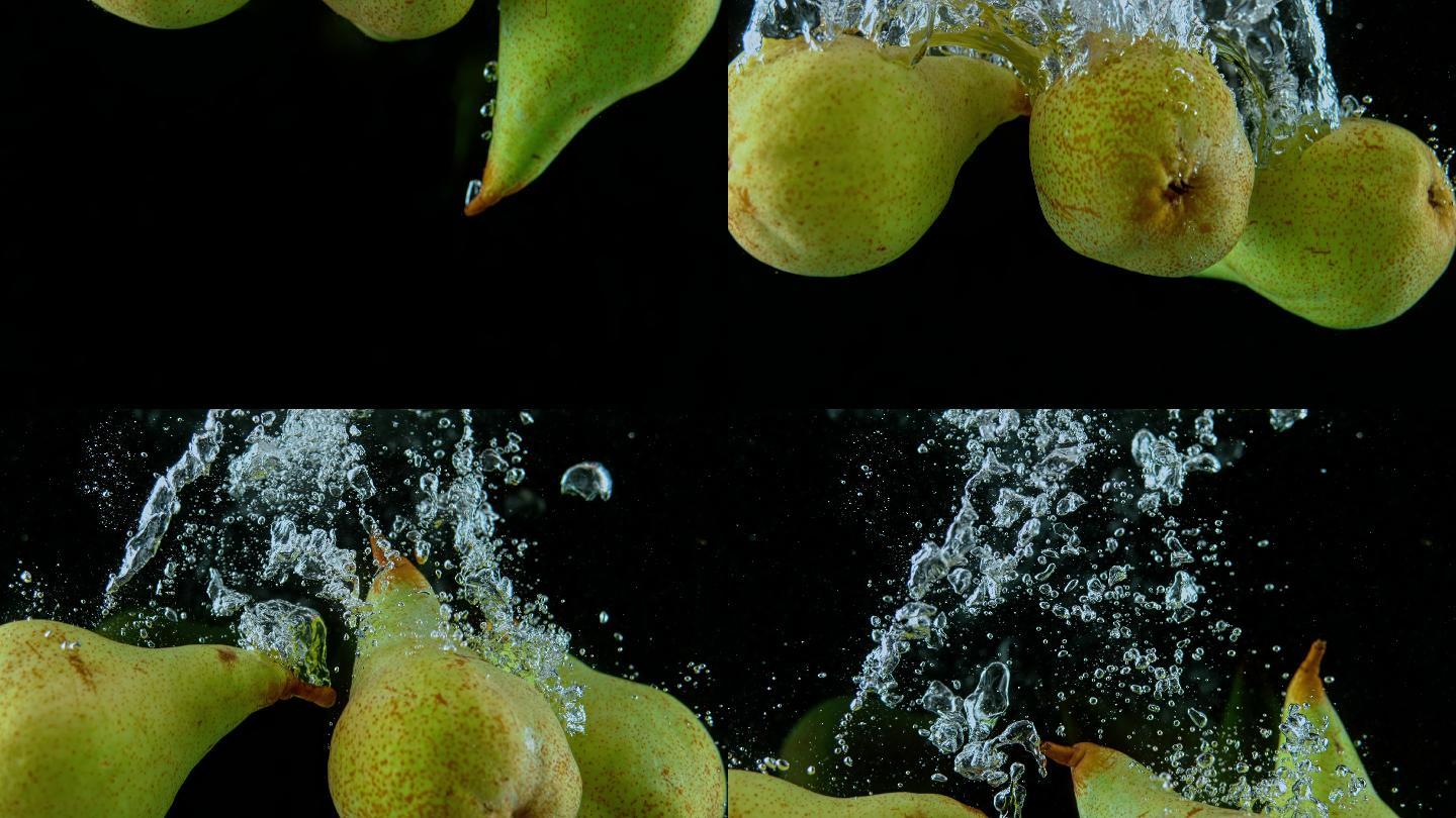 缓慢的梨子掉进水中并产生漩涡状的气泡