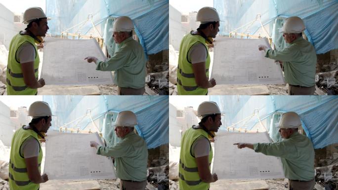 拉丁美洲主管和建筑师在施工现场一边谈话一边查看蓝图