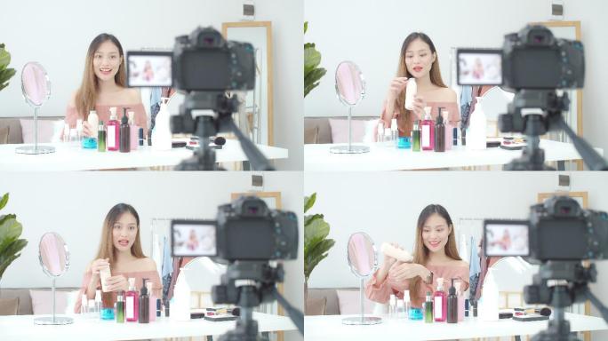 这位美丽的亚洲女性博主正在展示如何化妆和使用化妆品。在摄像机前录制家中的vlog视频直播。商业在线对
