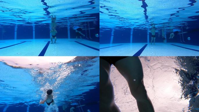低角度观看中国亚裔男子游泳运动员在游泳池中游泳