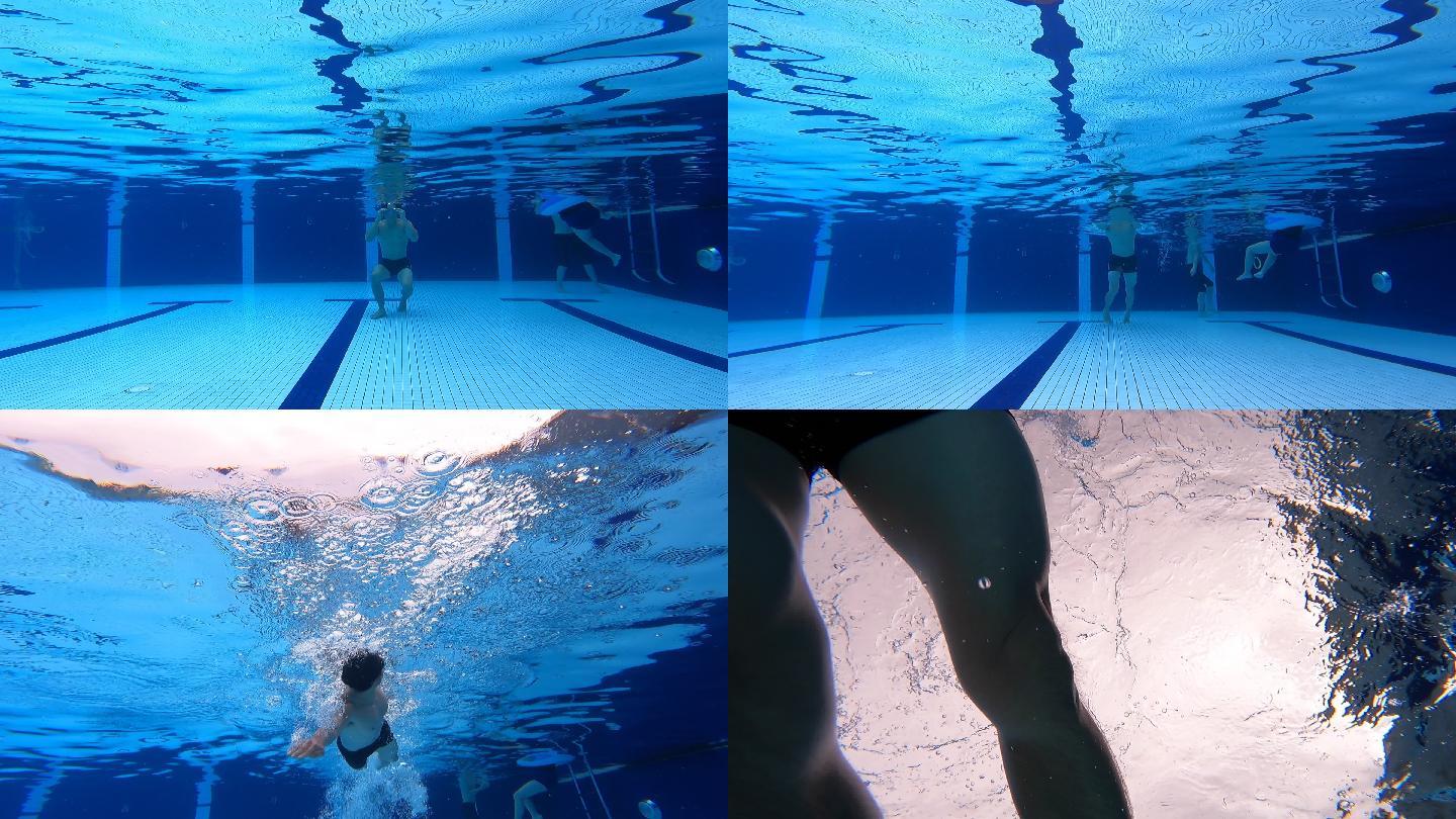 低角度观看中国亚裔男子游泳运动员在游泳池中游泳