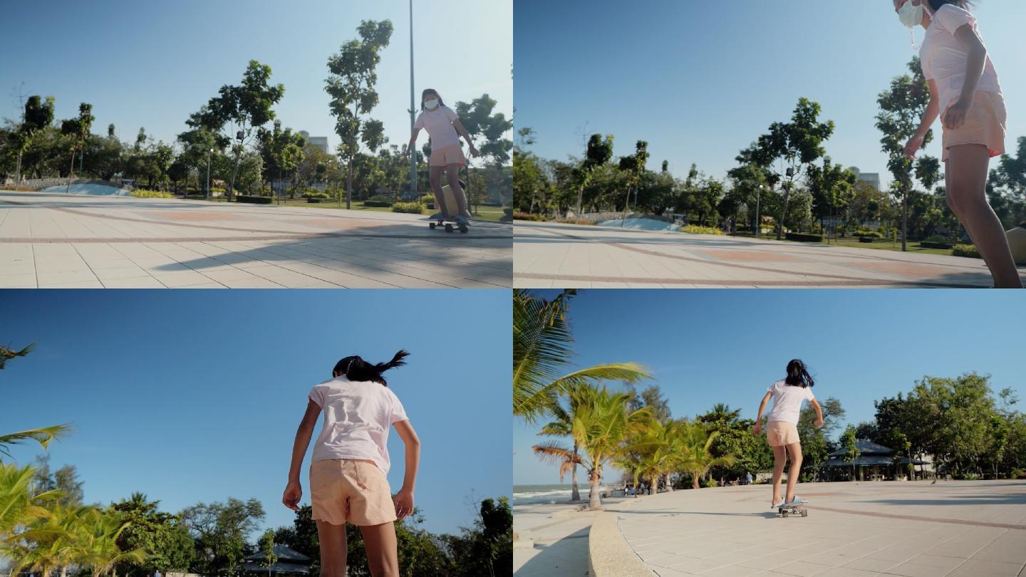 阳光明媚的日子里，亚洲女孩在公园户外玩冲浪滑板，椰子树背景，生活方式理念。