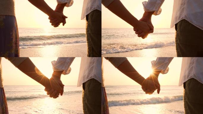 情侣们手牵手在海滩上。