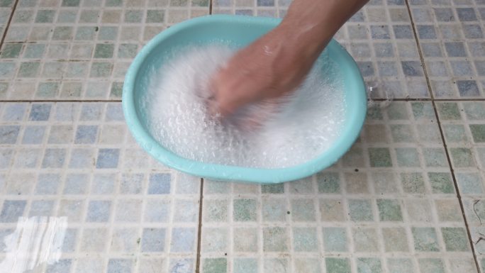 在一个小塑料碗中搅拌肥皂水。