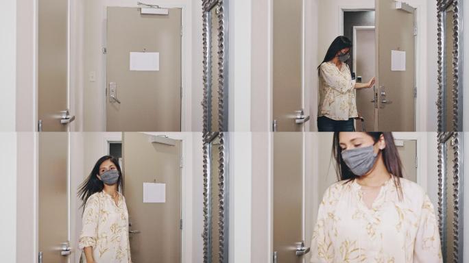 中年妇女戴着防护面罩进入酒店房间