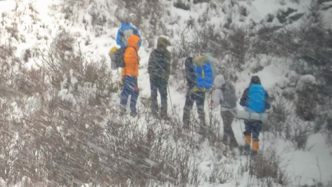 四川阿坝暴风雪中的徒步旅行者穿越丛林