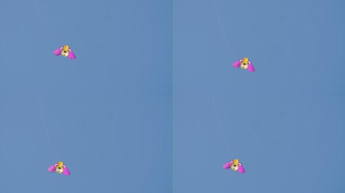 五颜六色的风筝在晴朗的蓝天上飞翔。