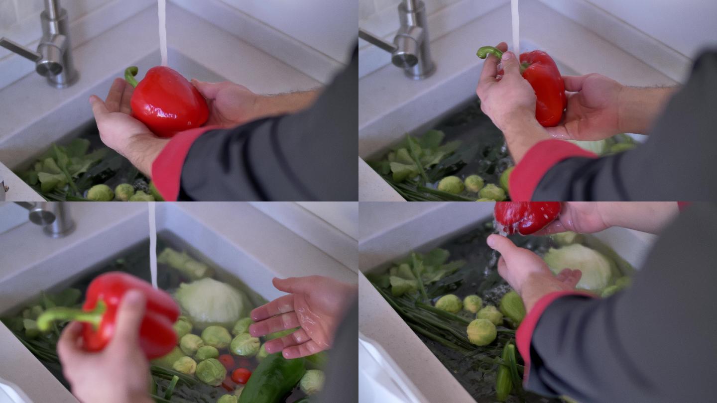厨师在厨房水槽上的自来水下清洗红甜椒