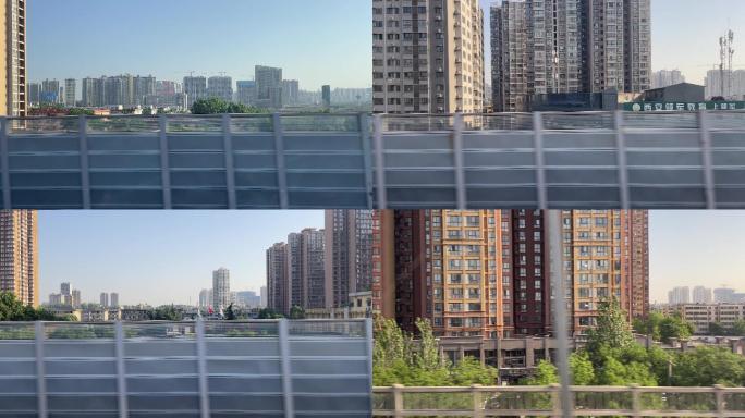 高铁动车中窗外的城市建筑群