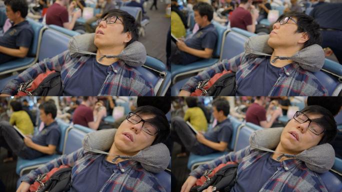 亚洲旅行者在机场候机楼用旅行枕睡觉