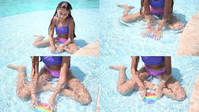 美丽的女孩在游泳池里享受着抗应激彩虹般的烦躁