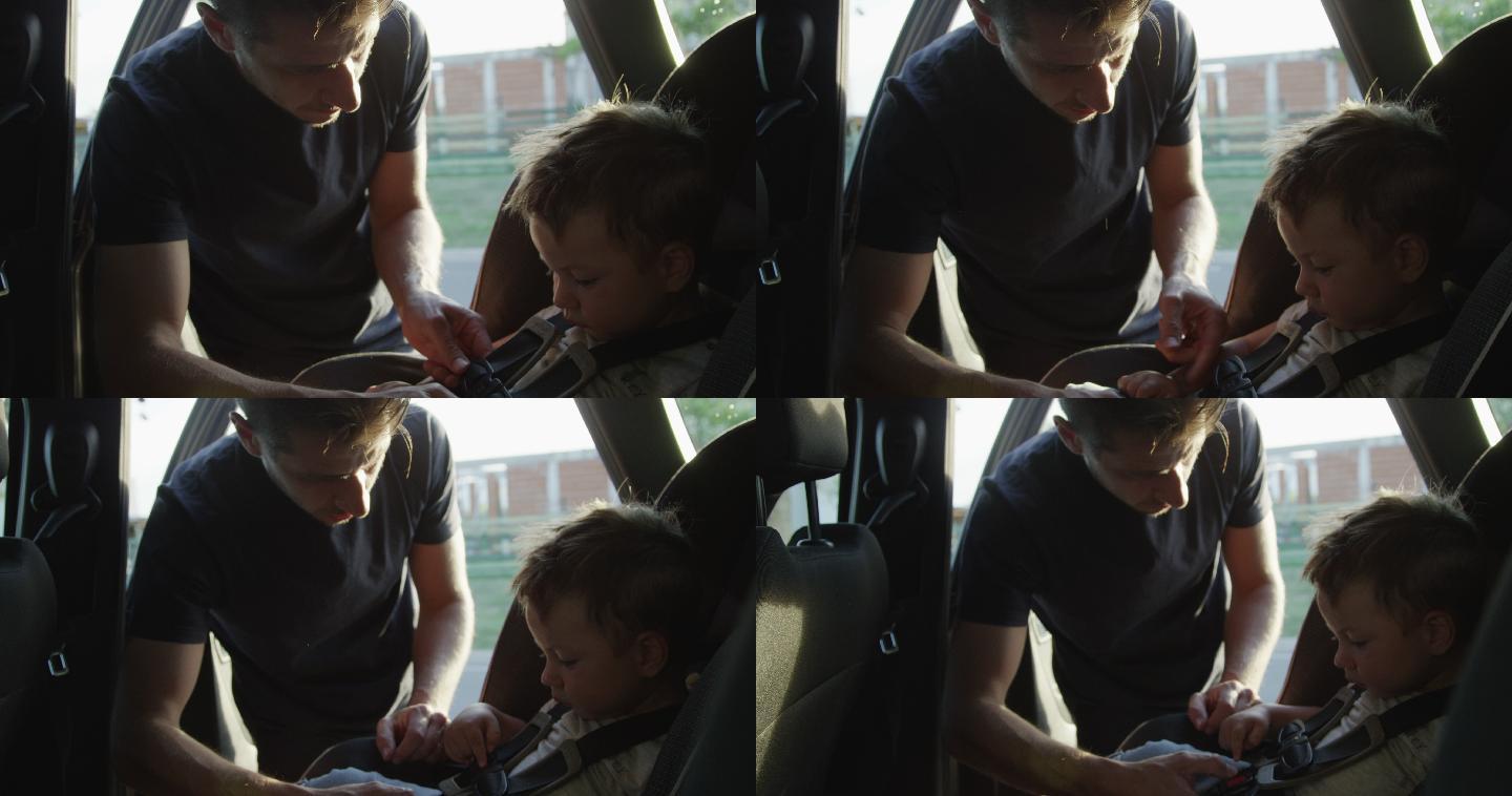 父亲坐在车里给儿子系安全带