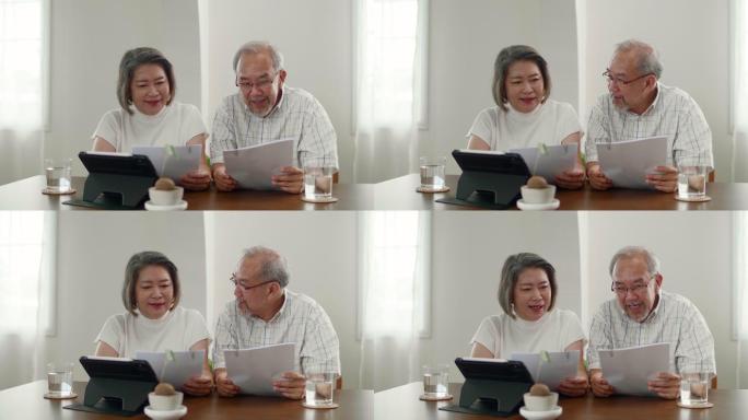 老年夫妇使用数字平板电脑技术管理家庭预算
