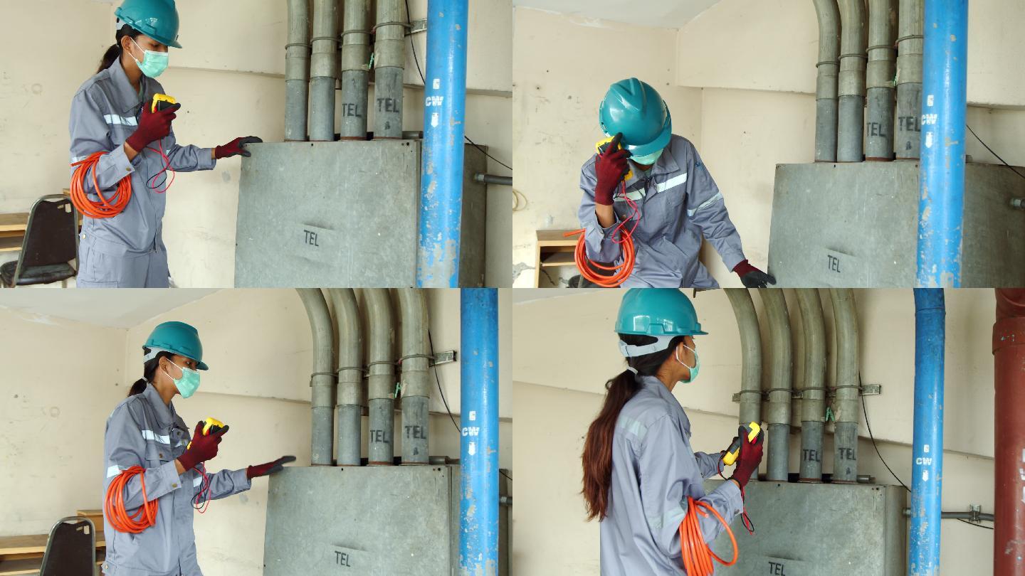 亚洲女技术员检查员检查建筑物内管道的泄漏状态。工程师女性触摸