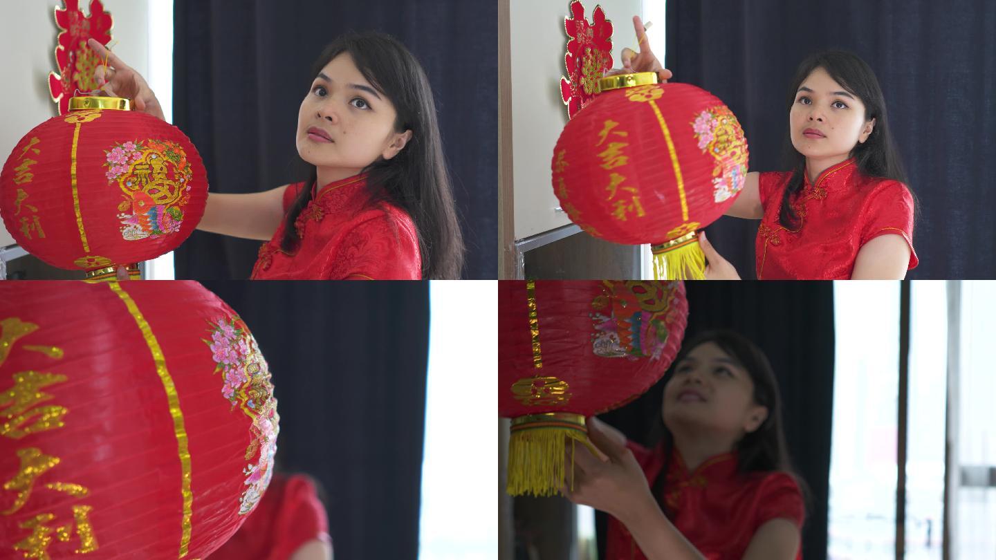 美丽的亚洲年轻女子为中国新年装饰她的房子