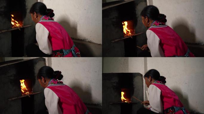 农村妇女点火做饭