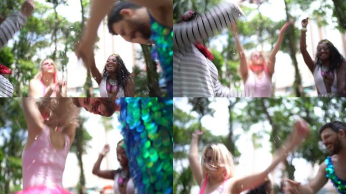巴西狂欢节上，朋友们玩得很开心，拿着五彩纸屑跳舞