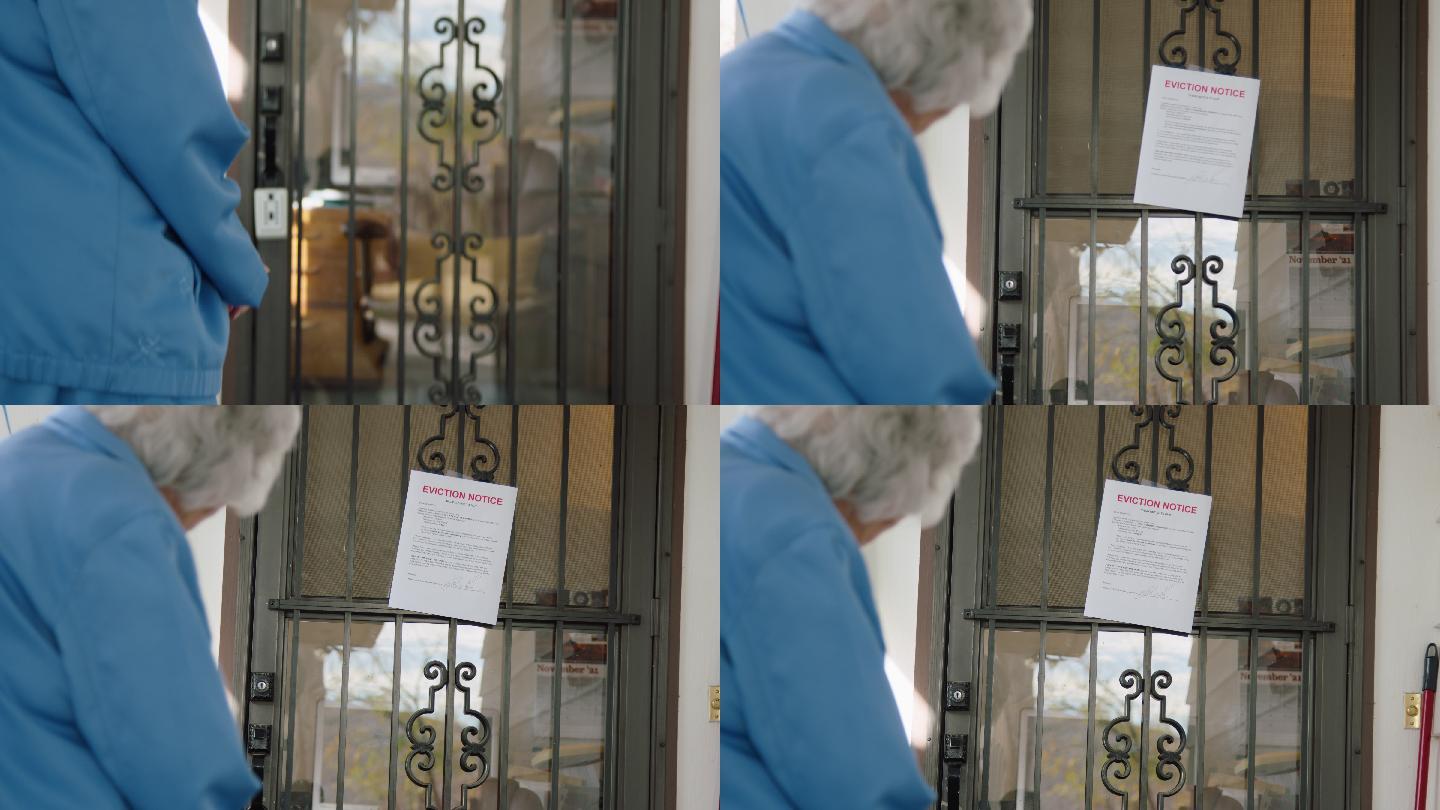 一位100岁的老妇人拿着拐杖站在家门口看驱逐通知
