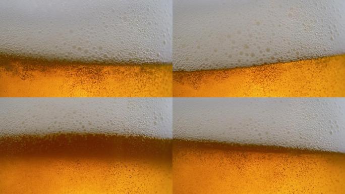 缓慢移动的啤酒泡沫在玻璃杯中移动