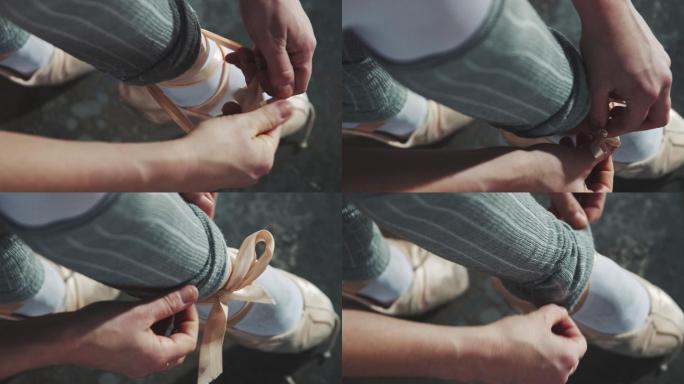 年轻的芭蕾舞演员系着pointe鞋的缎带