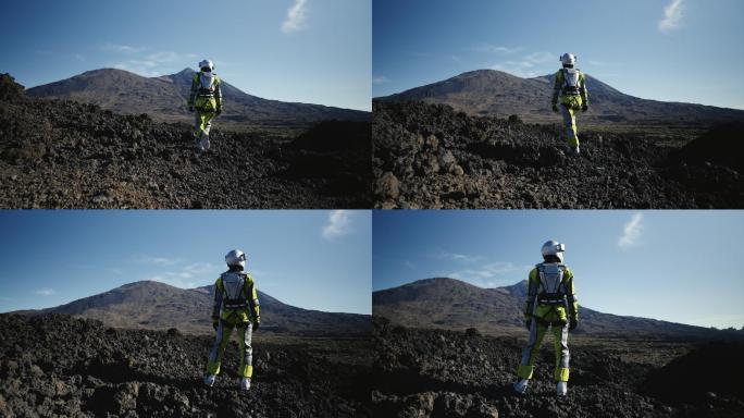 在荒凉的星球上漫步。女宇航员探索灰色山脉。看着干燥的火山景观