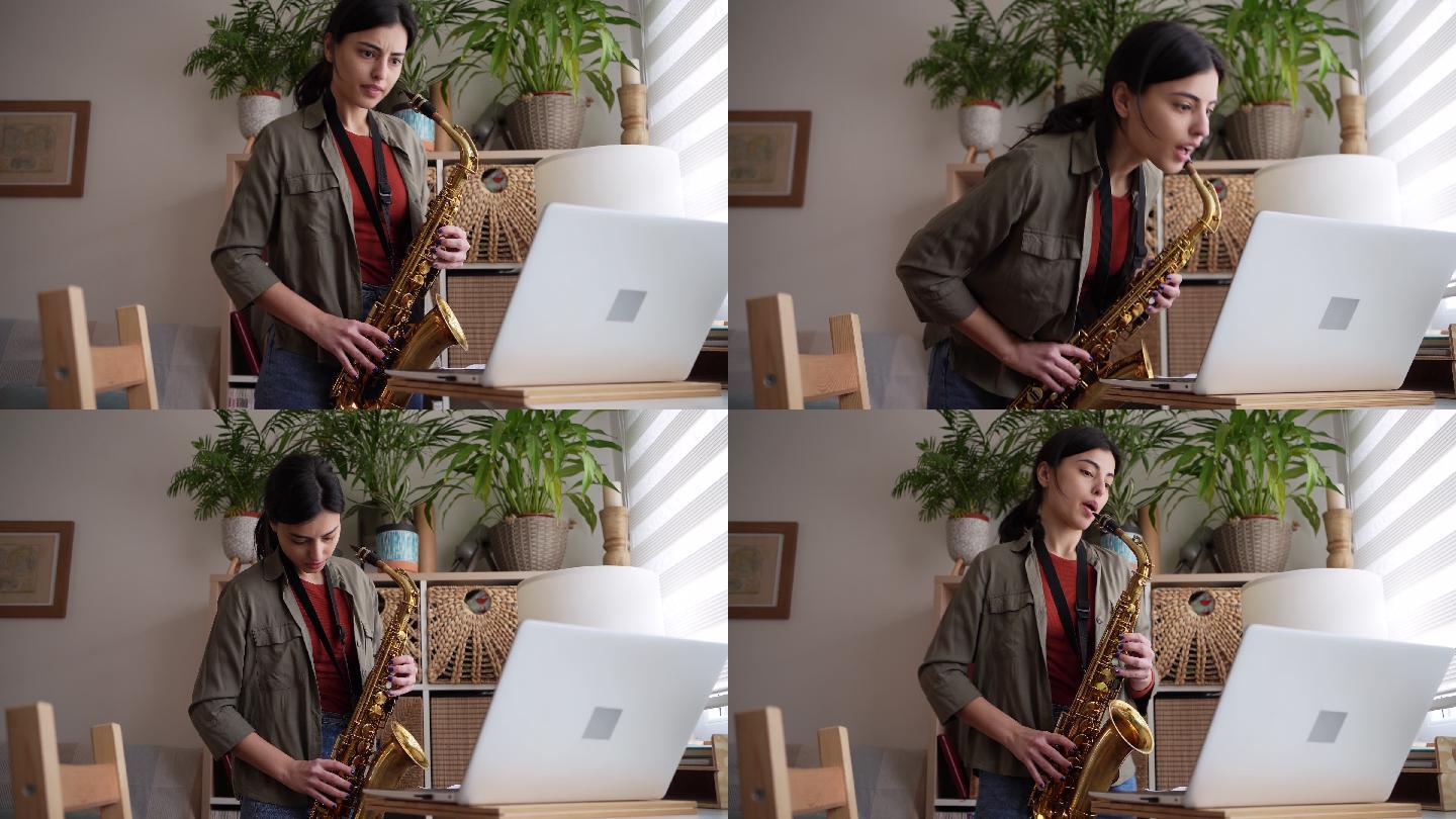 高加索女性，在笔记本电脑上观看在线教程，同时学习萨克斯管演奏