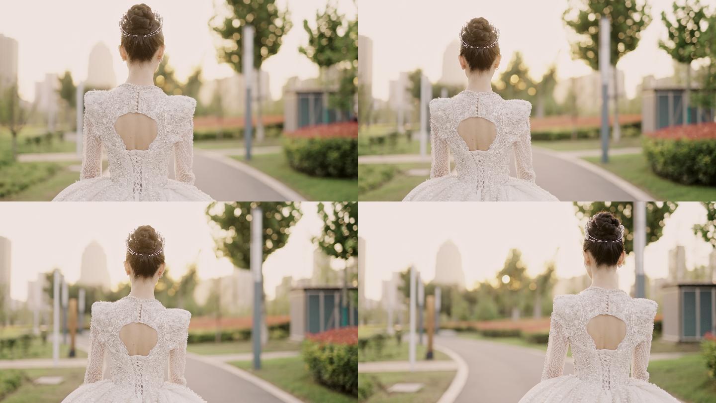 穿着白色婚纱的年轻美丽的亚洲新娘，在花园里散步，从后面拍摄，慢镜头