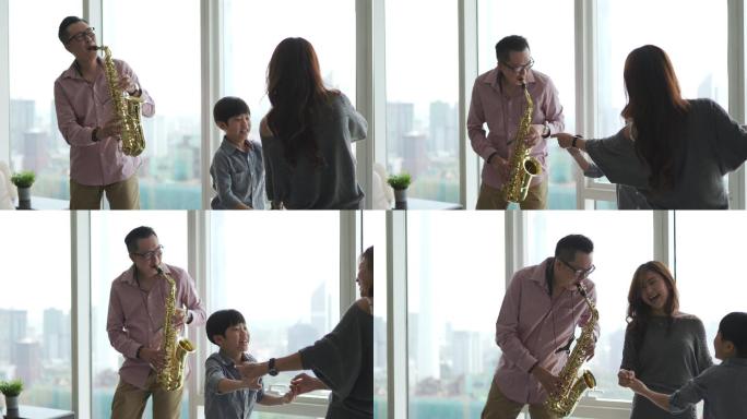 亚裔中国父亲喜欢在周末闲暇时间和家人在家吹萨克斯管