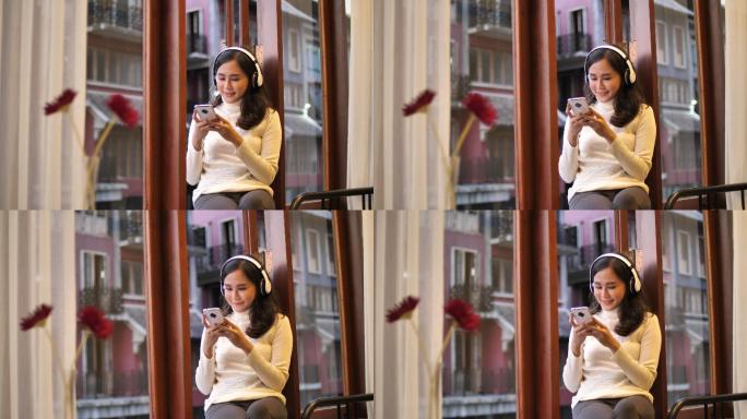 年轻的亚洲女性戴着耳机欣赏音乐