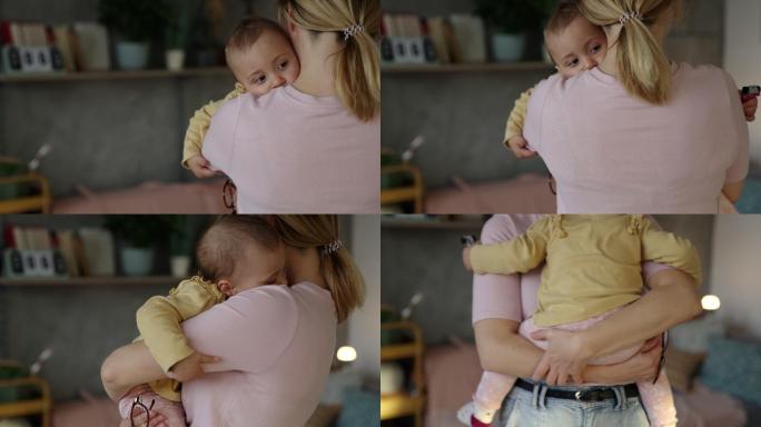 一位年轻的新妈妈把她的女婴抱在怀里