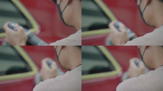 一名亚洲男子使用汽车抛光工具保养汽车漆面