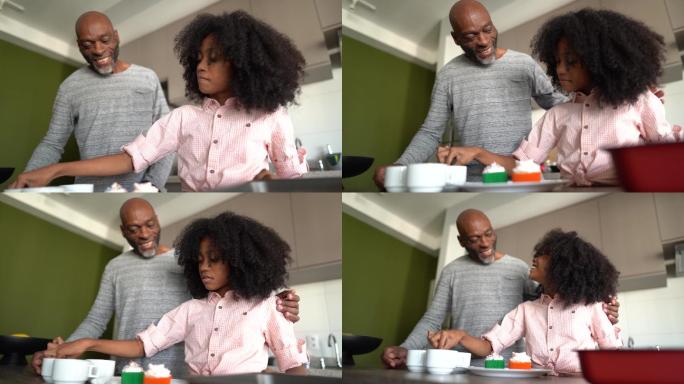 父亲和女儿在家装饰纸杯蛋糕