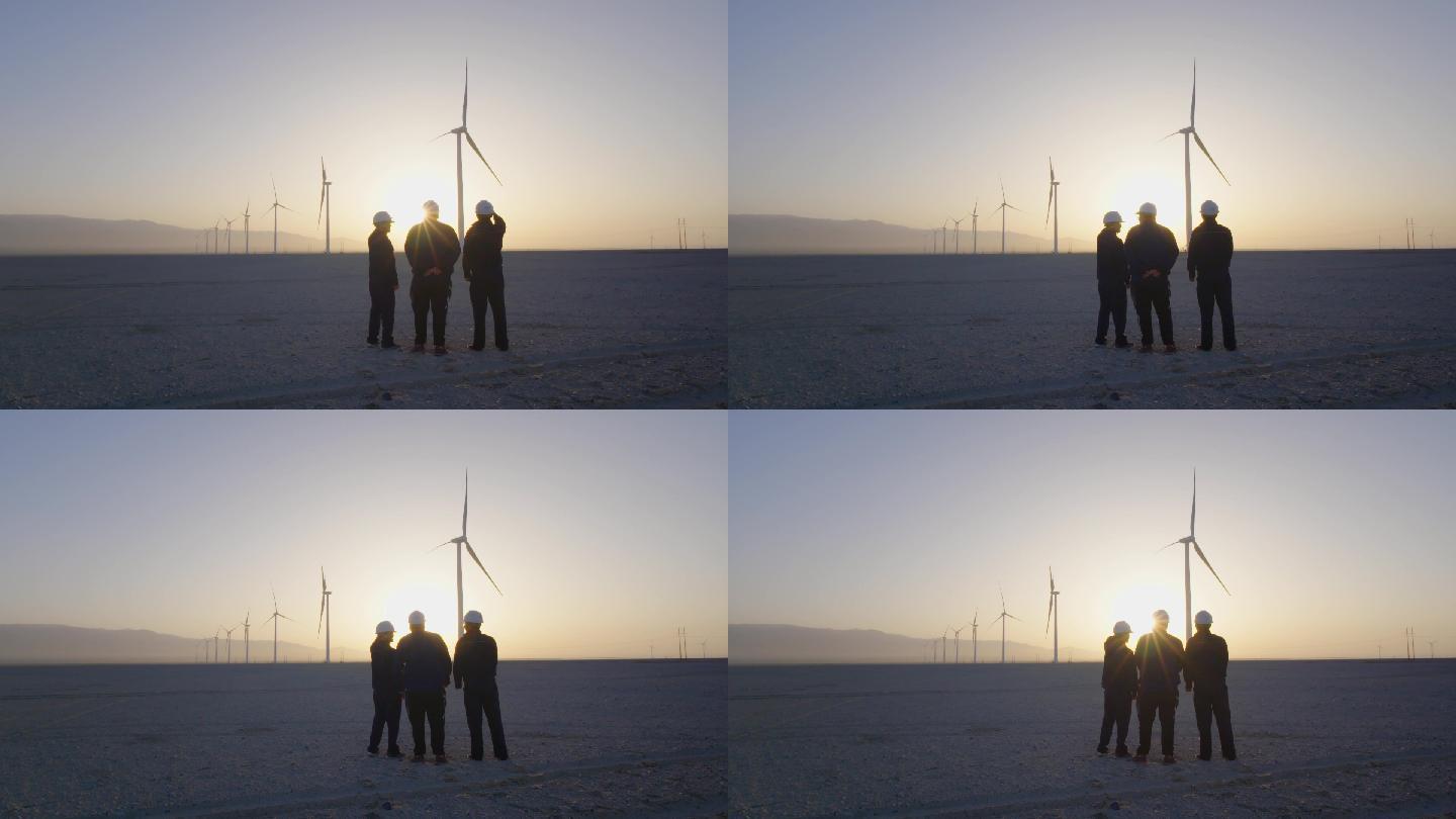 三个工作人员逆光站在风力发电车前讨论展望