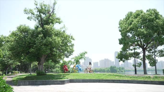 阳光正好在公园骑自行车的女生