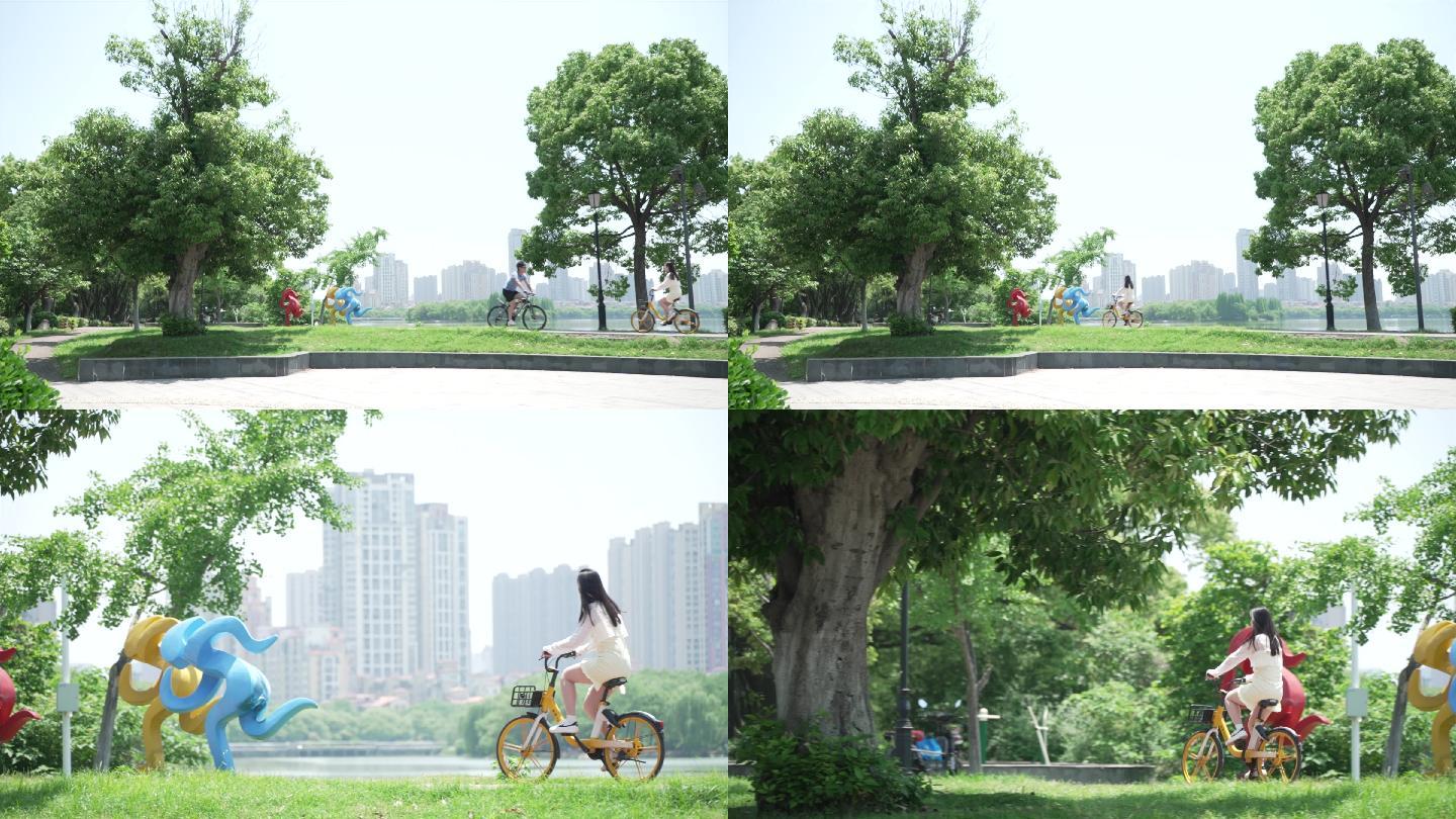 阳光正好在公园骑自行车的女生