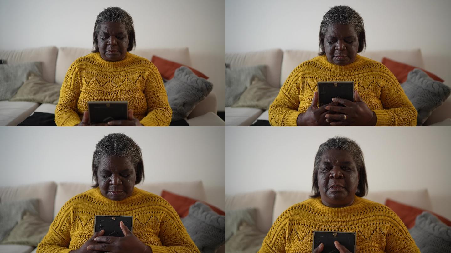 一位老妇人看着一张在家失踪的照片的肖像