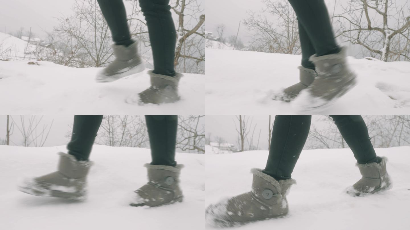 女人在雪中行走雪地靴