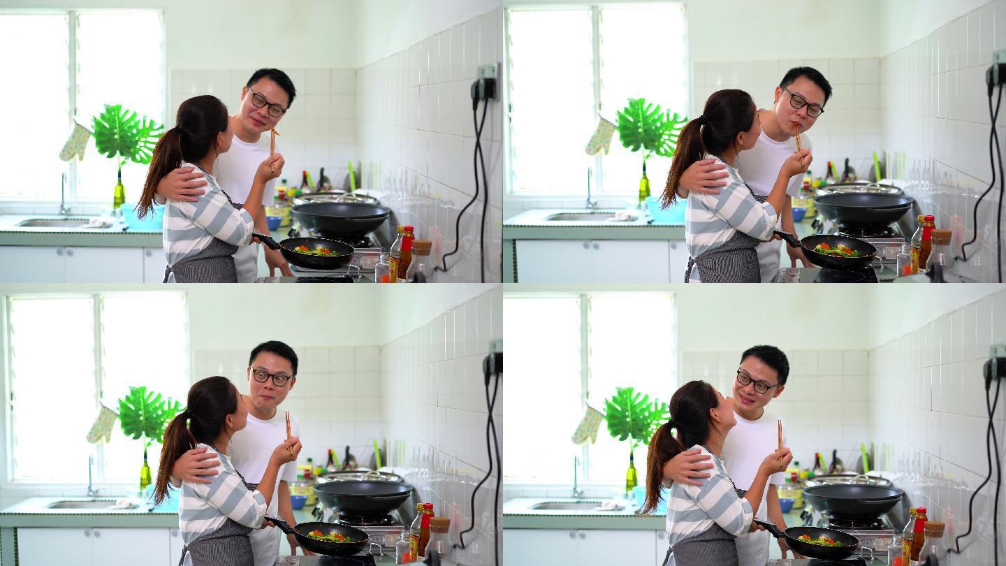 亚洲华人男女在厨房炒杂菜