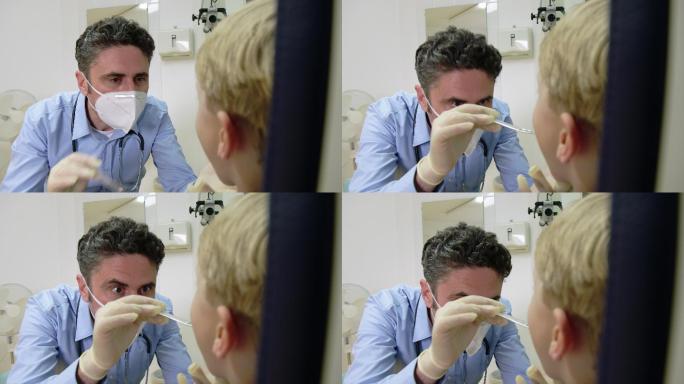 儿科医生用压舌器检查儿童咽喉