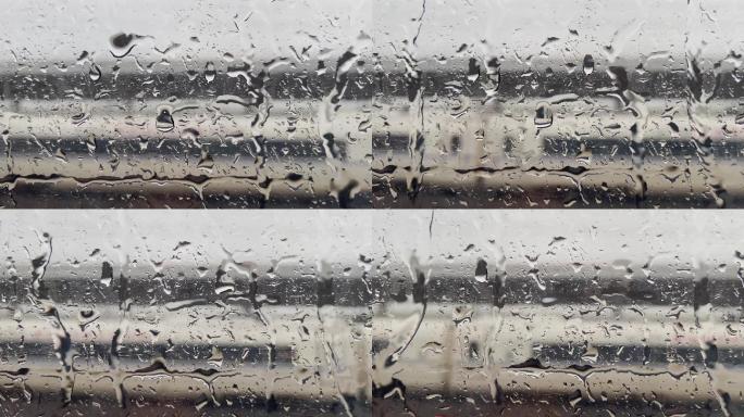 雨天高铁车厢玻璃窗上滑落的水滴