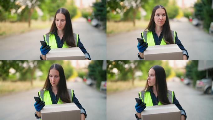 女性送货员使用智能手机在街上查找客户地址