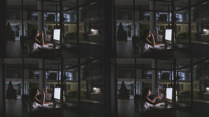 4k视频片段，一名年轻女商人在夜间办公室工作时看起来很紧张