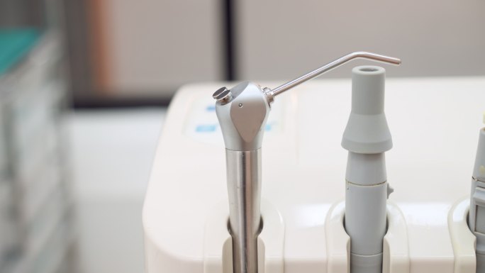 摇摄和特写：牙科单元带有唾液喷射器的空气吸入系统，为牙医在医院补牙做准备
