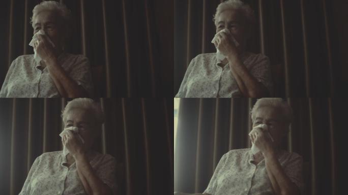 老妇人打喷嚏肖像捂鼻子