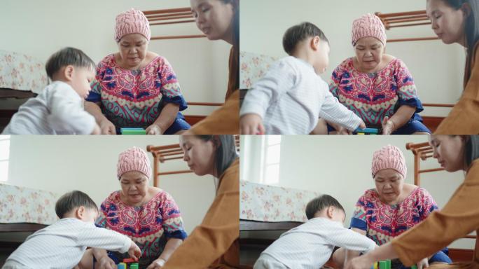 癌症祖母与孙子玩玩具积木