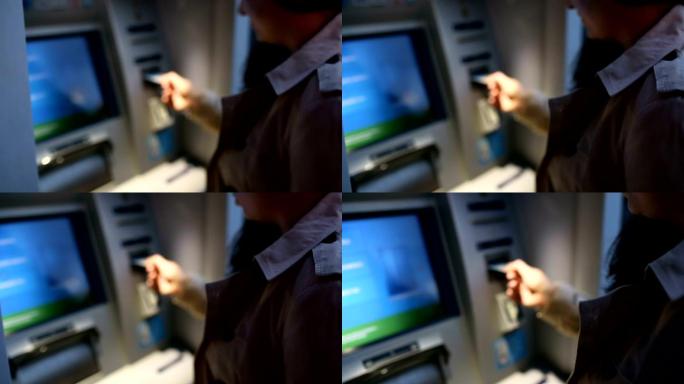 年轻女子在ATM机上插入信用卡