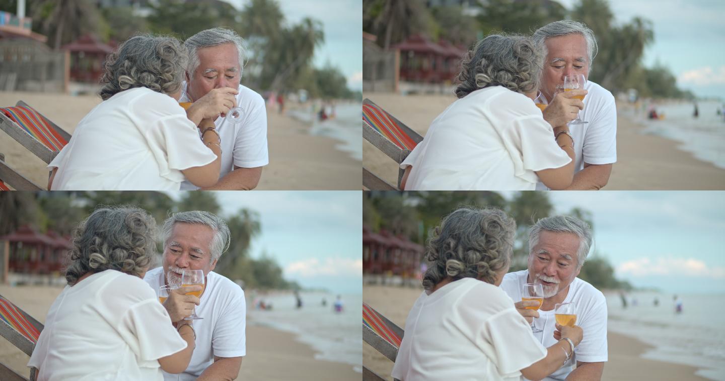 SLO MO成熟夫妇在海滩喝酒