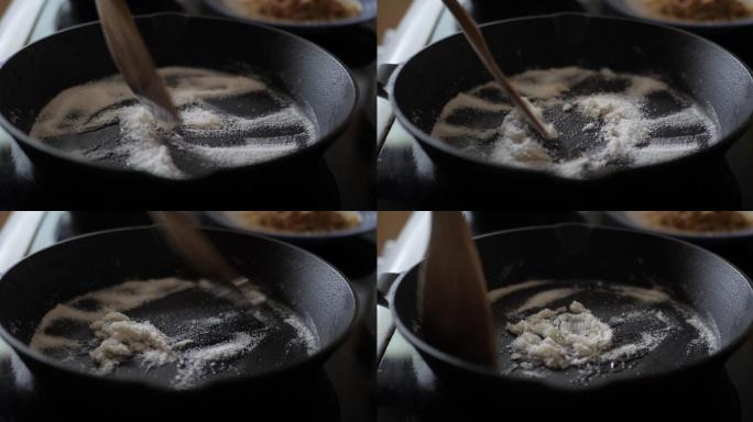 在铸铁锅中熔化砂糖